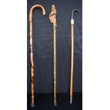 A root wood handled walking cane together with a carved horn handled cane and another cane. 93cm (3)