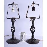 A PAIR OF ANTIQUE HAMMERED STEEL IRON CANDLESTICK LAMPS with spiral twist bodies. 47 cm high.