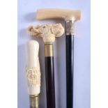 AN ANTIQUE IVORY HANDLED WALKING CANE together with two other novelty canes. Largest 90 cm long. (3)