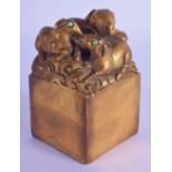 A CHINESE GILT BRONZE SEAL inset with coral and turquoise. 9 cm x 5.5 cm.