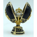 A small carved hardstone egg decorated with gilt metal & opens displaying a mosque. 7cm (2)