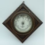 An antique James Arnold aneroid barometer set in a carved wood frame 22 x 22cm.