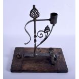 A RARE ANTIQUE SCOTTISH J BENNET OF FIFE WROUGHT IRON RUSHNIP TYPE CANDLE upon a wood plinth. 26 cm