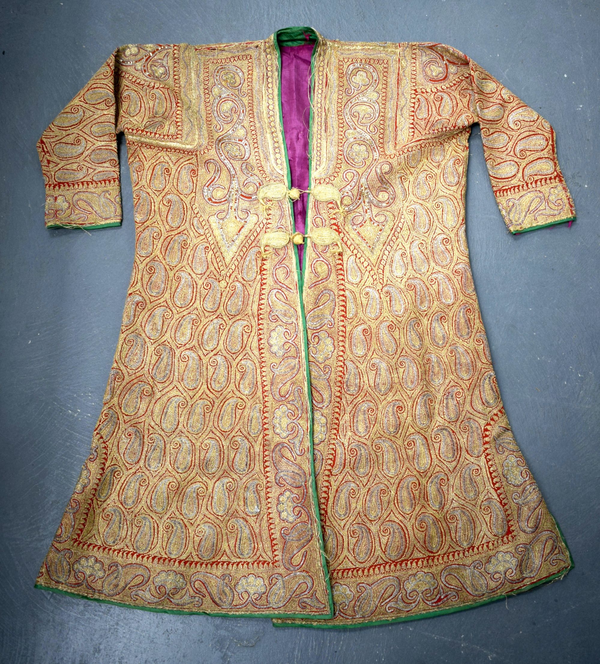 AN EARLY 20TH CENTURY INDIAN EMBROIDERED GOLD SILK JACKET decorated with foliage. 100 cm x 125 cm.
