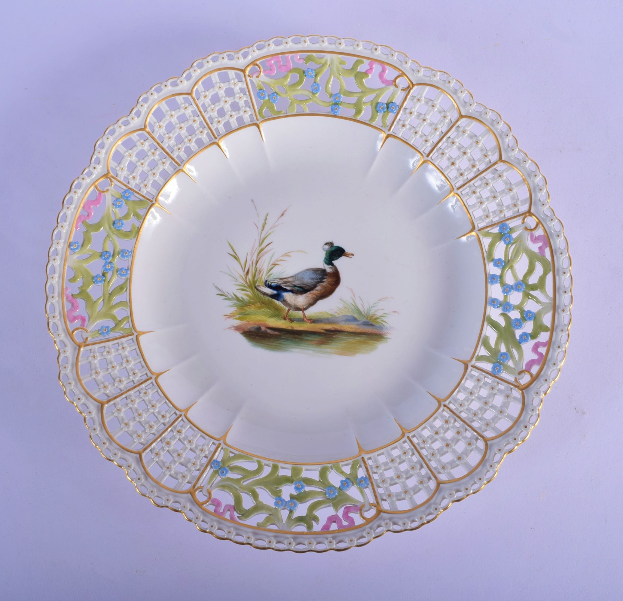AN ANTIQUE MEISSEN RETICULATED PORCELAIN DISH painted with a duck. 24.5 cm diameter.