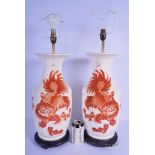 A PAIR OF CHINESE PORCELAIN VASES 20th Century, decorated with shishi dogs, converted to lamps. 65 c