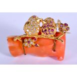 AN UNUSUAL VINTAGE YELLOW METAL RUBY AND DIAMOND CORAL BROOCH. 18 grams. 4 cm x 3 cm.