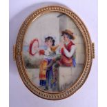 AN ANTIQUE PAINTED IVORY BROOCH depicting two gypsies playing instruments. 16 grams. 5.5 cm x 4.75 c