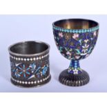 AN ANTIQUE RUSSIAN SILVER AND ENAME EGG CUP together with a similar Russian enamel napkin ring. 102