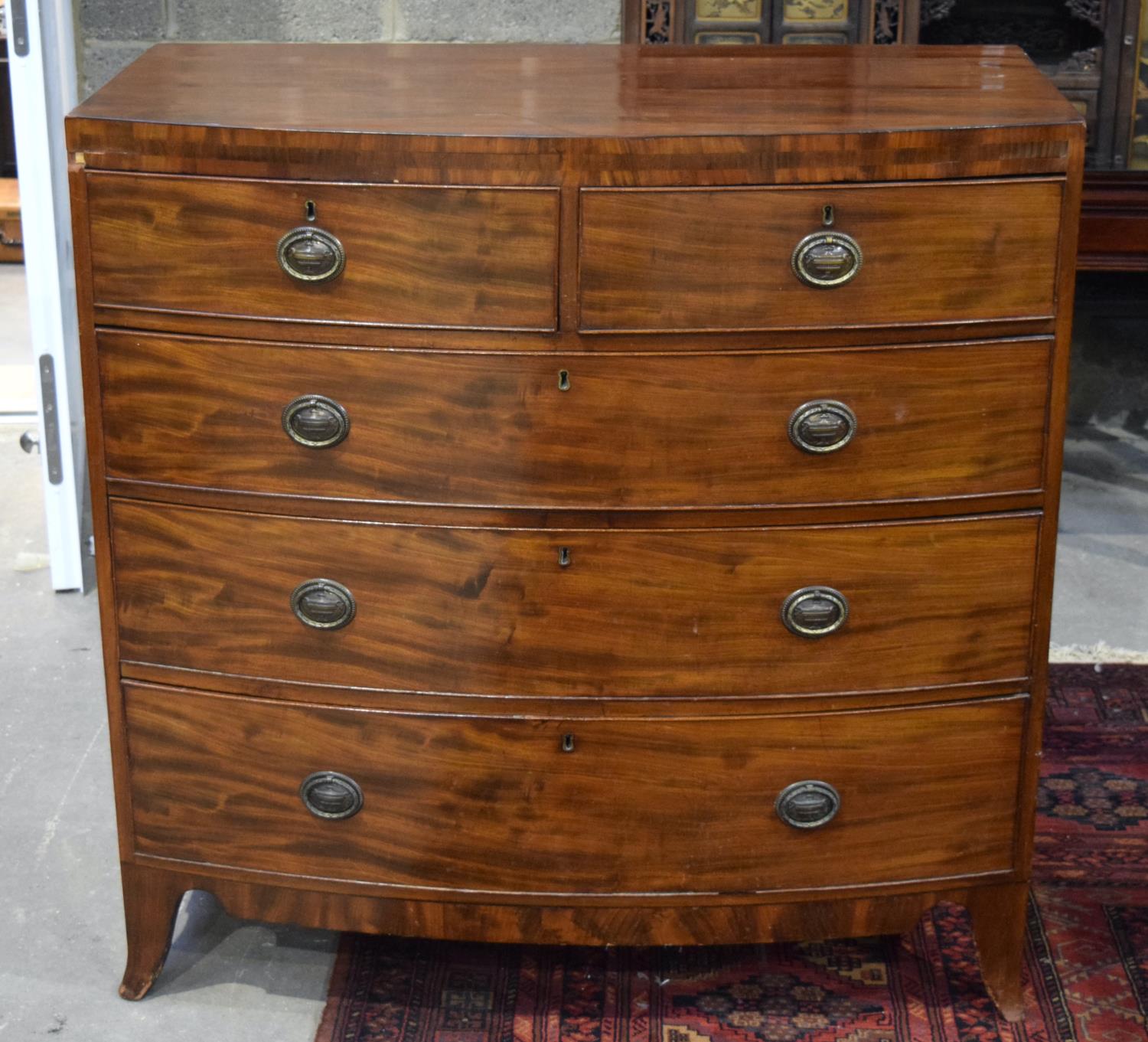 A GEORGE III BOW FRONTED VENEERED FIVE DRAWER CHEST OF DRAWERS. 107 x 107 x 57 cm.