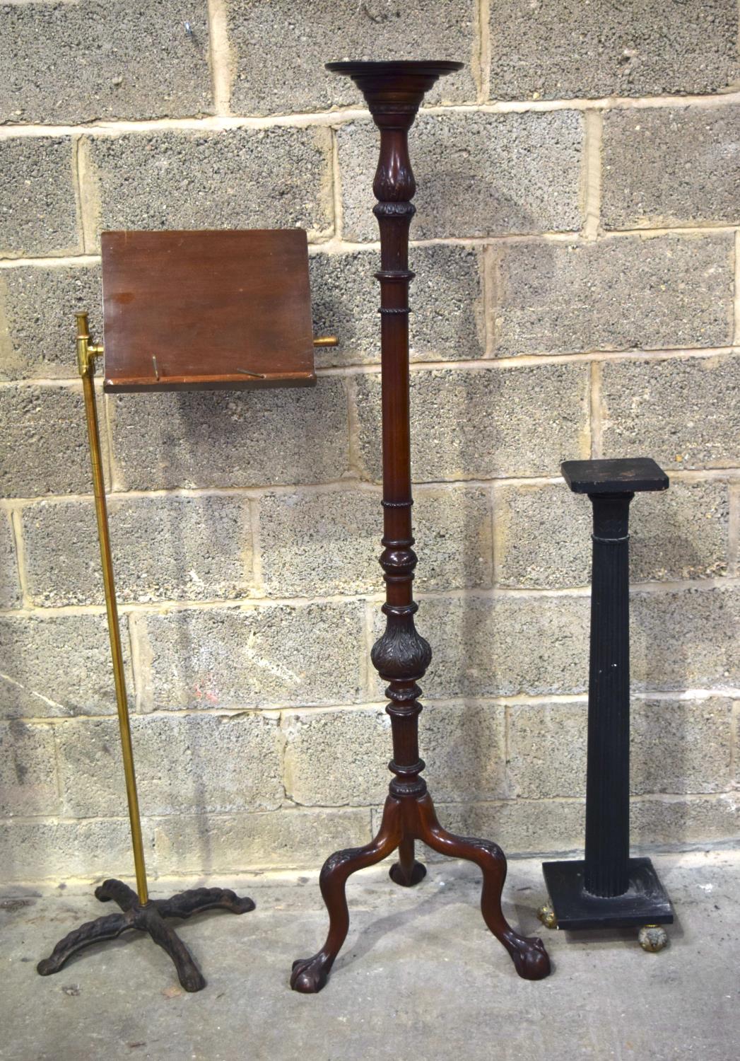 A LOVELY CHIPPENDALE STYLE TORCHERE, alongside a music stand and a slender black stand. Largest 156