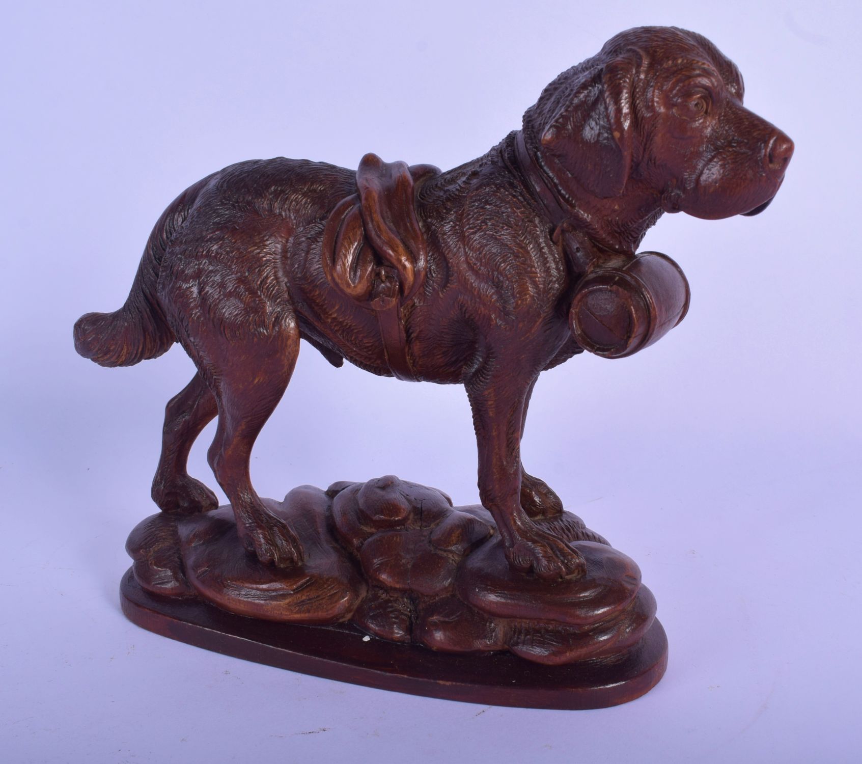 A 19TH CENTURY BAVARIAN BLACK FOREST CARVED WOOD FIGURE OF A HOUND modelled roaming upon a naturalis