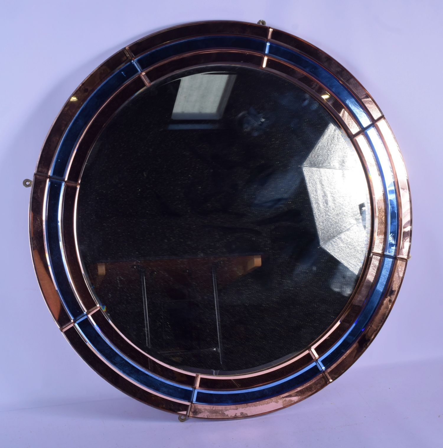 A CHARMING ART DECO PINK AND BLUE GLASS CIRCULAR MIRROR of stylised form. 70 cm diameter.