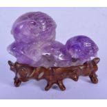 A LATE 19TH CENTURY CHINESE CARVED AMETHYST FIGURE OF TWO BIRDS Late Qing, modelled upon a rocky out