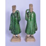 A PAIR OF 19TH CENTURY CHINESE GREEN GLAZED POTTERY FIGURES modelled in the Tang Style. 25 cm high.