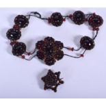 AN ANTIQUE GARNET NECKLACE together with a brooch. 34 grams overall. Necklace 28 cm long. (2)