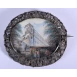 A 19TH CENTURY CONTINENTAL SILVER AND PAINTED IVORY BROOCH depicting a castle wall before trees. 22