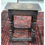 AN 18TH CENTURY RECTANGULAR COUNTRY OAK STOOL with carved legs. 52 x 46 cm.