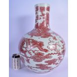 A 19TH CENTURY CHINESE COPPER RED GLAZED PORCELAIN TIANQIUPING DRAGON VASE Qing, decorated all over