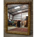 A LARGE VINTAGE COUNTRY HOUSE MIRROR with extensive gilt floral border. 142 x 113 cm