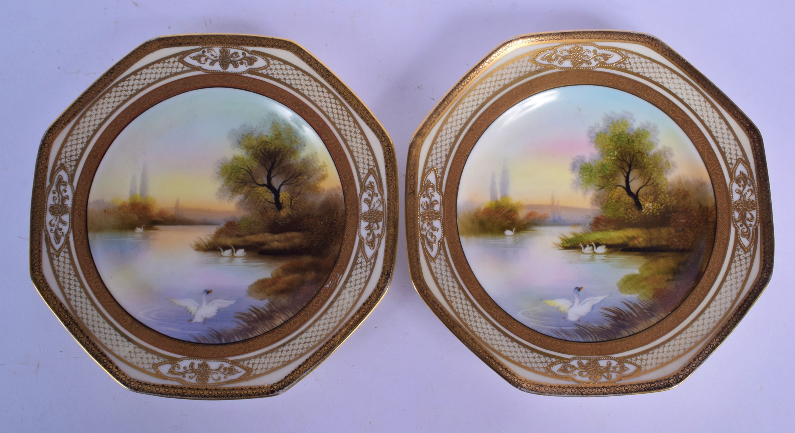 A PAIR OF JAPANESE TAISHO PERIOD NORITAKE PORCELAIN PLATES painted with ducks upon a lake. 20.5 cm w