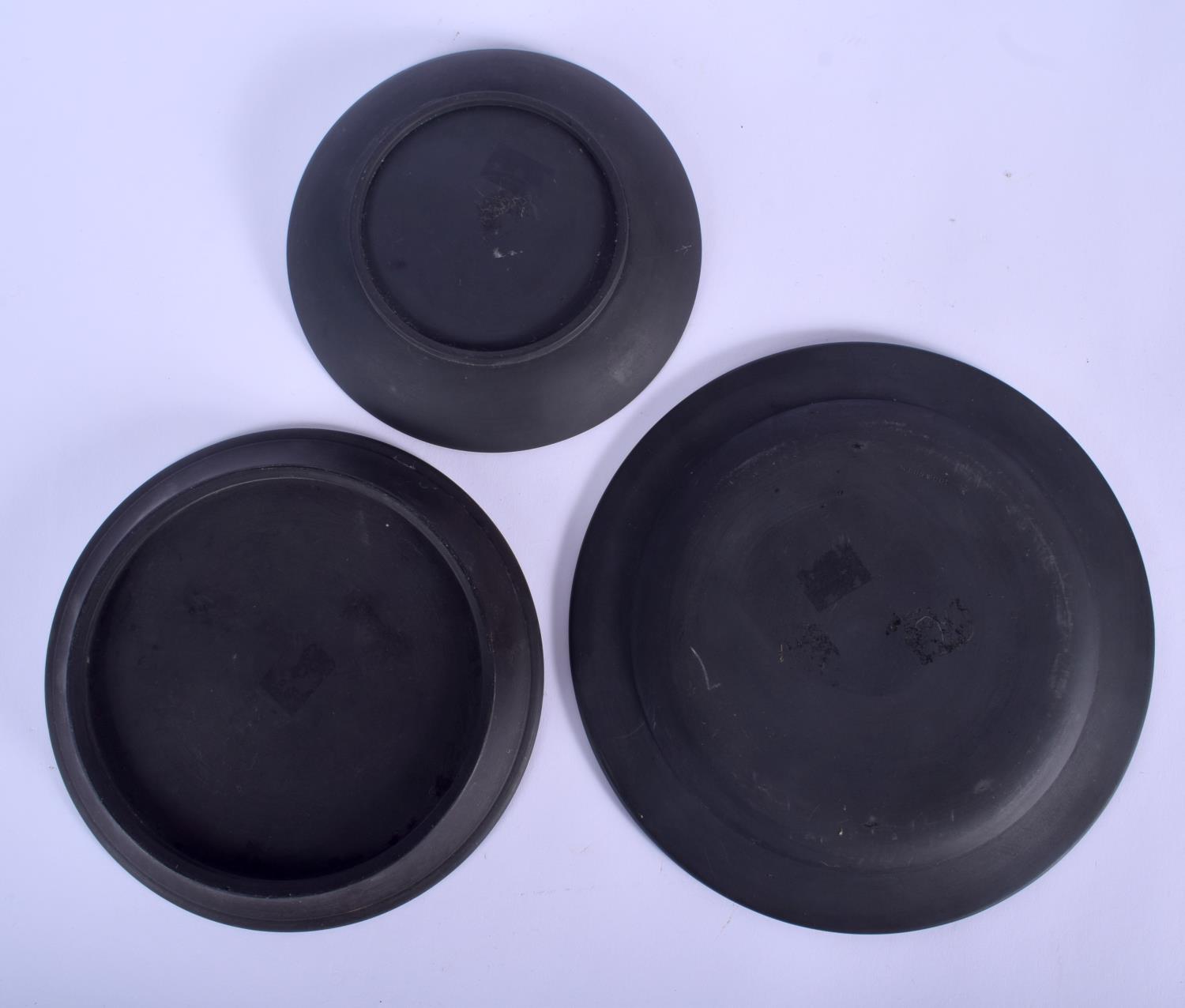 TWO 19TH CENTURY BLACK BASALT CIRCULAR PLATES one decorated with a star anthemion pattern, the other - Image 2 of 2