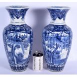 A LARGE PAIR OF EARLY 20TH CENTURY JAPANESE MEIJI PERIOD BLUE AND WHITE VASES painted with landscape