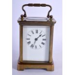 A BRASS CARRIAGE CLOCK. 10.8cm high (13.8cm with handle raised) x 7.9cm x 6.3cm with key