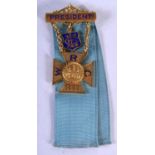 A WRC-WOMEN'S RELIEF CORPS BRASS COLOURED MEDAL WITH LIGHT BLUE RIBBON ATTACHED, DATED 1883, PRESID