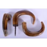 THREE 19TH CENTURY MIDDLE EASTERN CARVED RHINOCEROS HORN CANE HANDLES. 9.5 cm wide. (3)
