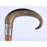 A 19TH CENTURY MIDDLE EASTERN CARVED RHINOCEROS HORN WALKING CANE with wood shaft. 90 cm long.