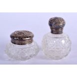 A SILVER TOPPED SCENT BOTTLES TOGETHER WITH A JAR AND COVER. Hallmarked Birmingham 1901 and 1902, S