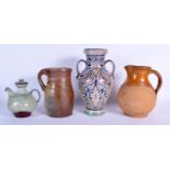 A TWIN HANDLED FAIENCE GLAZED JAR by El Emah, together with two pottery jugs and another. Largest 29