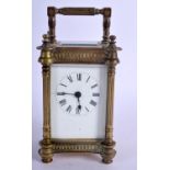 A BRASS CARRIAGE CLOCK. 13.5cm high (16.1cm with handle raised) x 8.5cm x 7cm with key