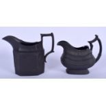 A 19TH CENTURY BLACK BASALT CREAM JUG decorated with foliage, together with another jug of plain OG