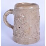 AN EARLY RHINELAND STONEWARE SALT GLAZED TANKARD probably 17th/18th century, decorated with a trader