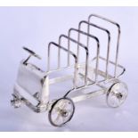 A SILVER PLATED TOAST RACK IN THE FORM OF A CAR. 14.5cm long, 13cm high