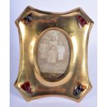 AN ARTS AND CRAFTS BRASS AND AGATE PHOTOGRAPH FRAME inset a Victorian photograph. 18 cm x 14 cm.