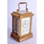 A CONTEMPORARY MINIATURE BRASS CARRIAGE CLOCK. 10 cm high inc handle.