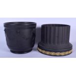 TWO WEDGWOOD BLACK BASALT JARDINIERES one with column base and buff anthemion decoration, the other