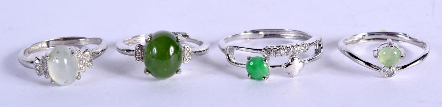 FOUR SILVER AND JADE RINGS. 6.5 grams. Largest ring T. (4)