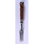 AN EARLY CARVED TREEN FRUITWOOD FORK with animal handle and steel fittings. 35 grams. 20 cm long.