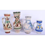 FOUR EASTERN EUROPEAN TIN GLAZED POTTERY JUGS in various forms and sizes. Largest 25 cm high. (4)