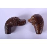 TWO BLACK FOREST STYLE CANE HANDLES one formed as a seal, the other as a dog. Largest 9 cm x 7 cm. (