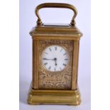 A MINIATURE BRASS CARRIAGE CLOCK. 7.4cm high (9.2cm with handle raised) x 5.1cm x 4cm