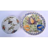 A 19TH CENTURY SPANISH FAIENCE TIN GLAZED CIRCULAR DISH painted with three flowers, together with a