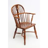 A YEW WINDSOR ARMCHAIR, of low hoop back form, 19th century, with shaped and pierced splat, baluster