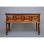 A JOINED OAK LOW DRESSER, late 17th century, the moulded edged plank top over two twin panelled