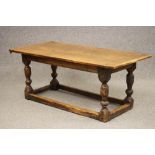 A JOINED OAK DINING TABLE, mid 17th century and later, the cleated plank top on channel moulded