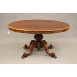 A VICTORIAN ROSEWOOD LOO TABLE, the moulded edged oval tilt top with plain frieze raised on turned